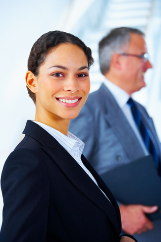 female consultant in suite smiling and looking at camera