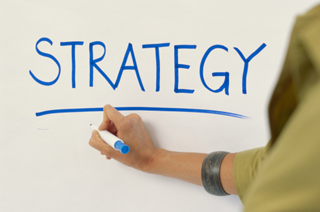 Image of a white board with the word strategy written on it